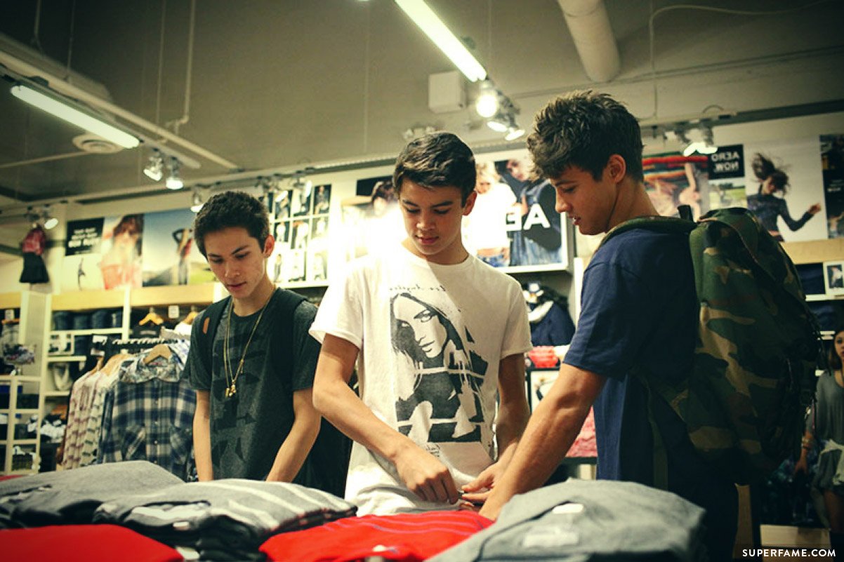 Cameron, Hayes and Carter admire shirts.