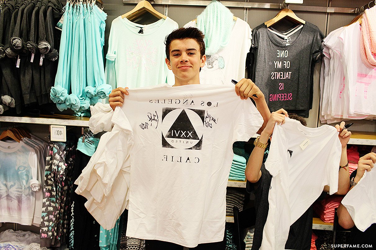 Hayes Grier holds t-shirt.