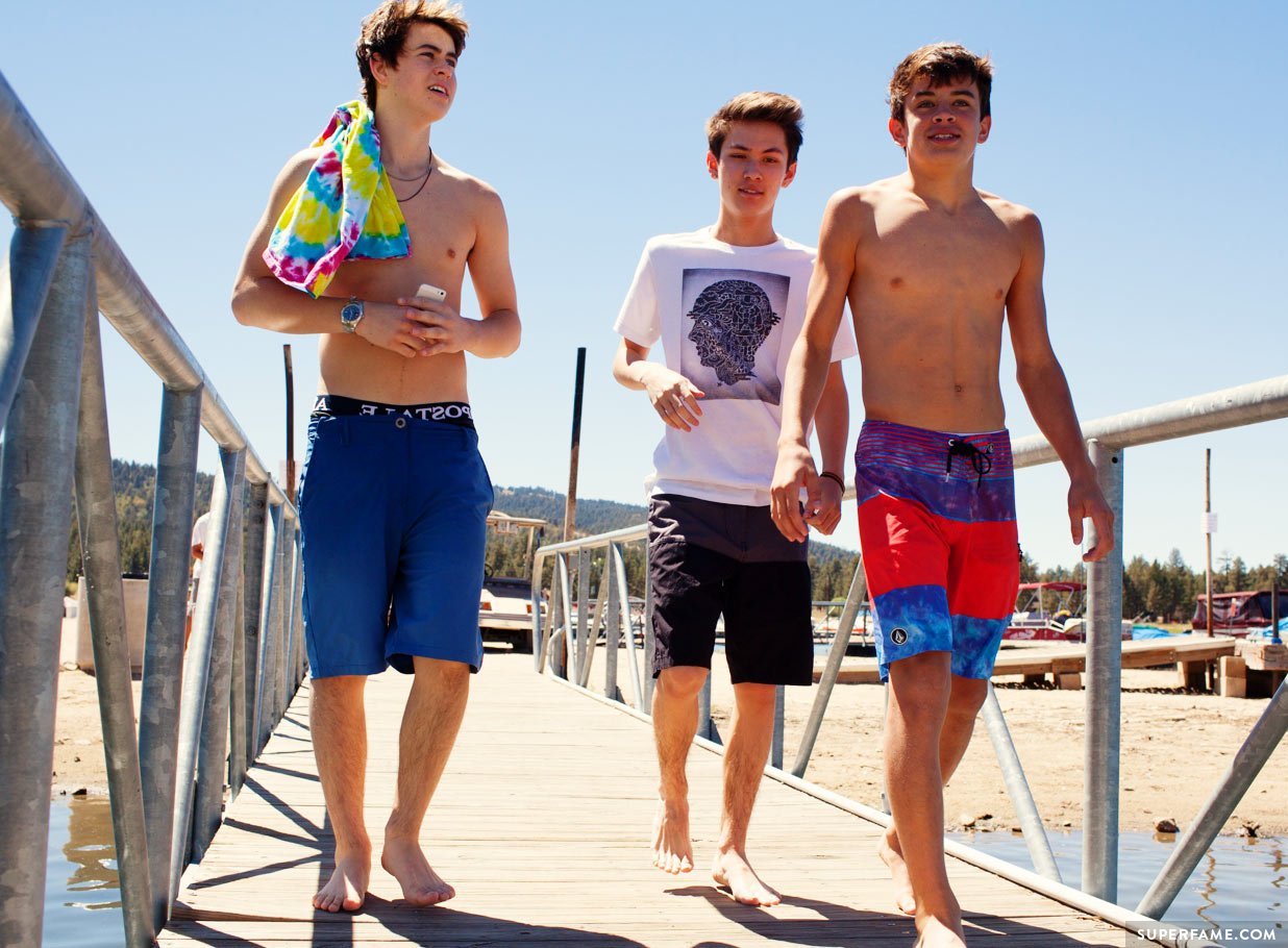 Hayes and Nash shirtless with Carter. 