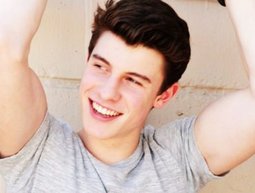 Shawn Mendes is smiling.