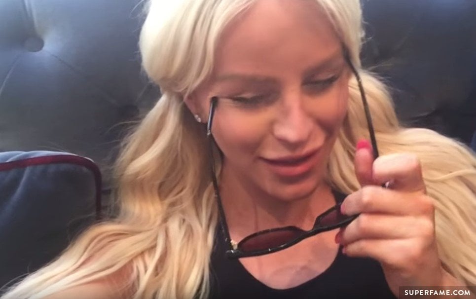 Gigi Gorgeous puts on her sunglasses.