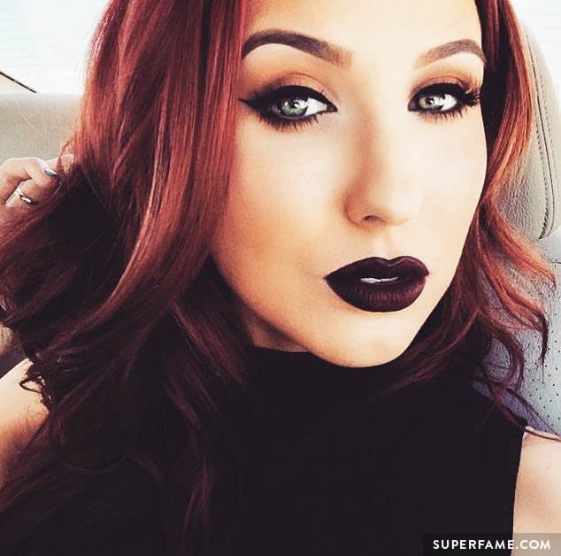 Jaclyn Hill shows off dark lipstick.