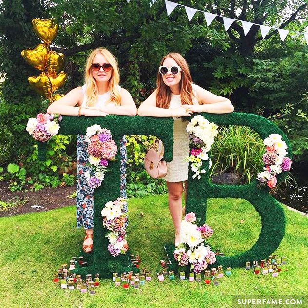 Tanya Burr poses behind her sign.