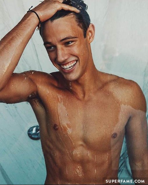 Cameron Dallas plays with his hair in the shower.