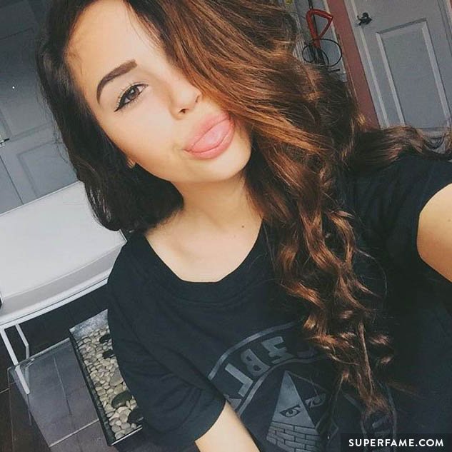 Maggie Lindemann sticks out her tongue.