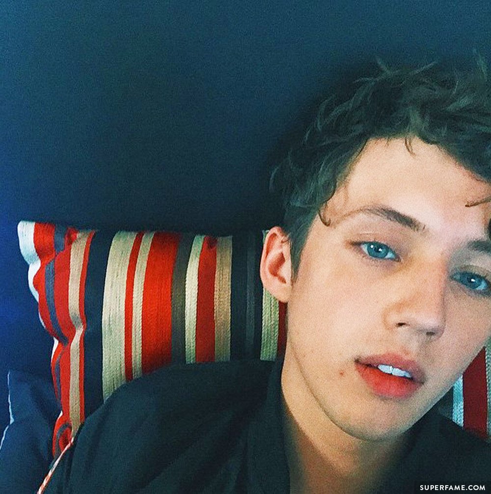 Troye Sivan on a colorful pillow.