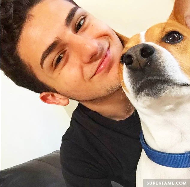 Twaimz smiling with a dog. 