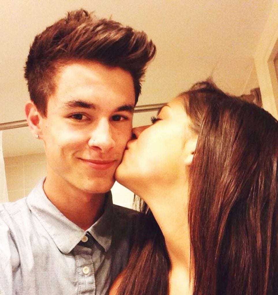 Andrea Russett plants a kiss on Kian.