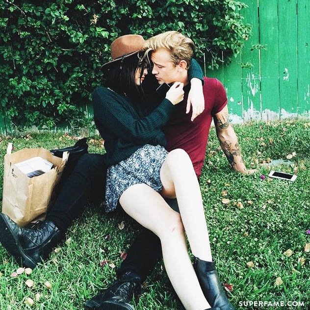 Jairus lounges on the grass with girlfriend Acacia.