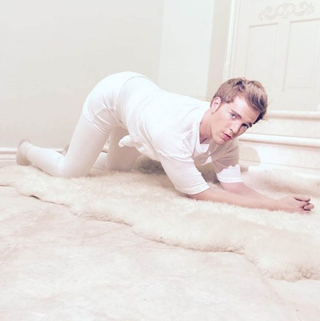 Shane Dawson poses in white.