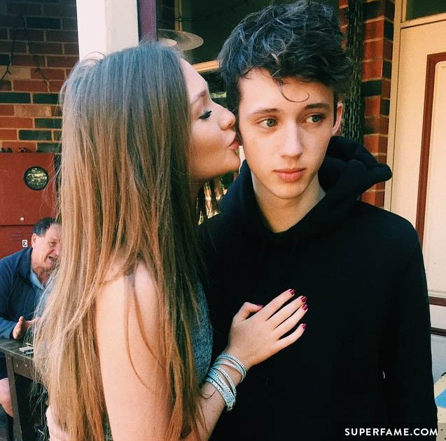 Troye Sivan gets kissed by a girl.