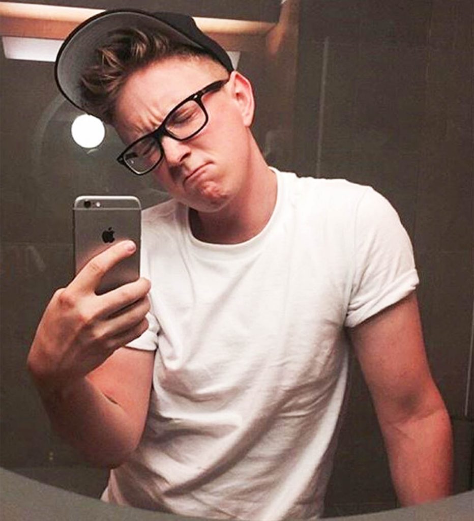 Tyler Oakley takes a classic mirror selfie.