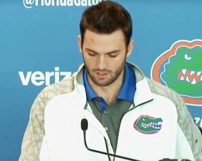 Will Grier is escorted away.