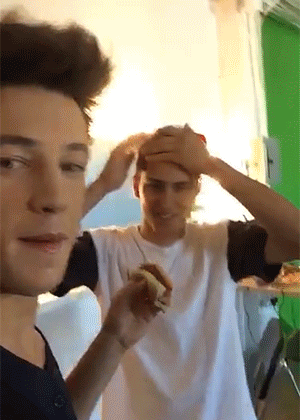 Cameron rubs Chris' forehead.