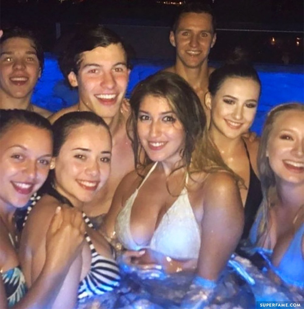 Shawn Mendes with girls in a pool.